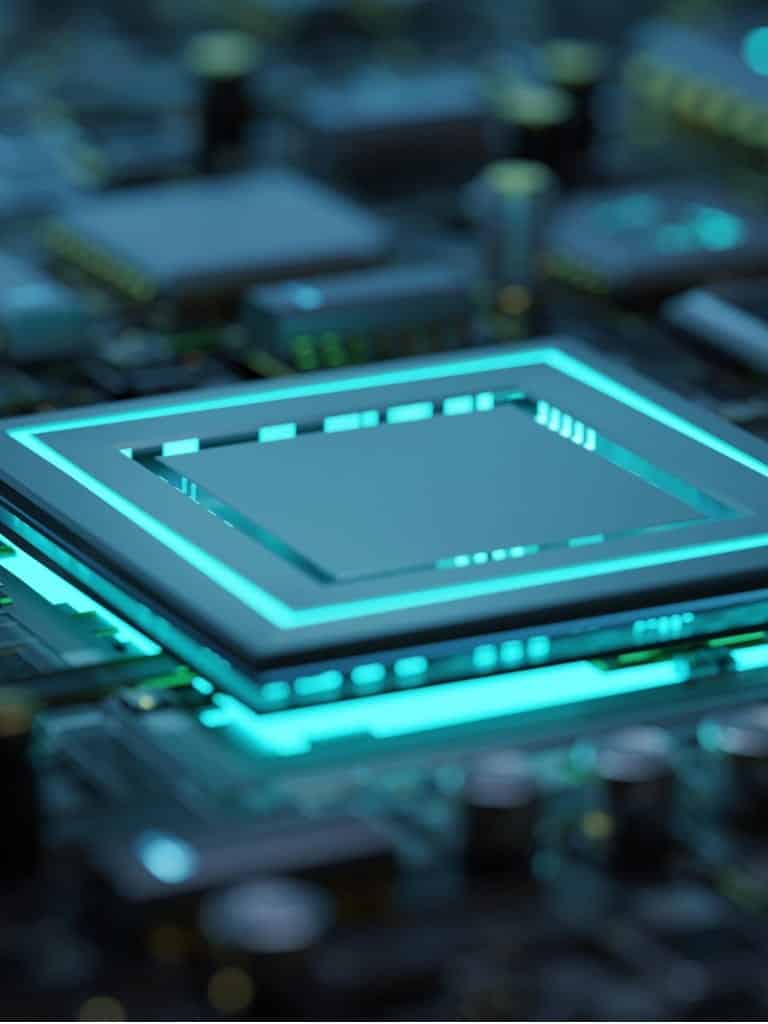 Close up of motherboard with selective focus on the main processor / micro chip with cyan backlit